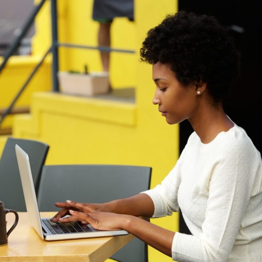 attractive-young-woman-using-laptop-outside-P9RLFGU@2x-1024x798-1.jpg